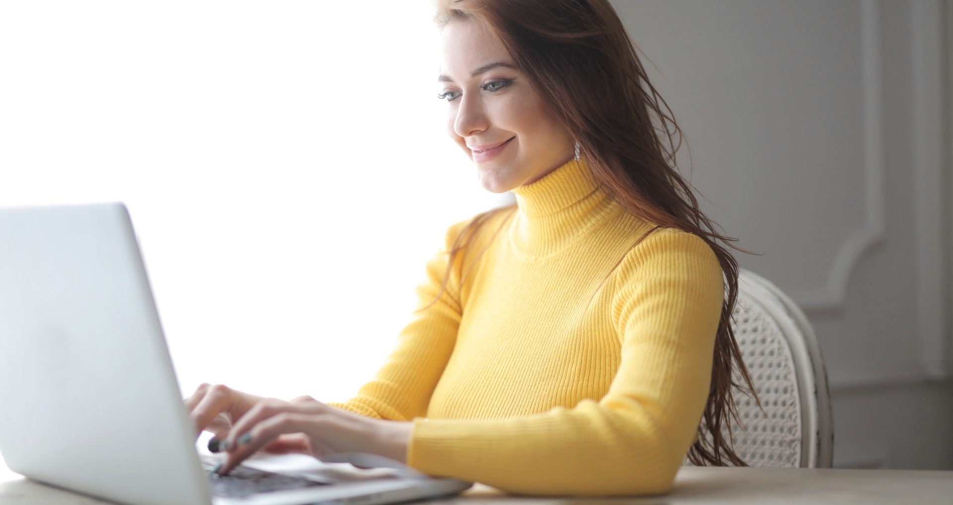 Business As Unusual for Travel Professionals 8 woman in yellow turtleneck sweater using laptop 3884186 e1585722095496